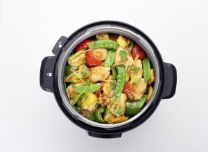 Multicooker overhead view with chicken and vegetables